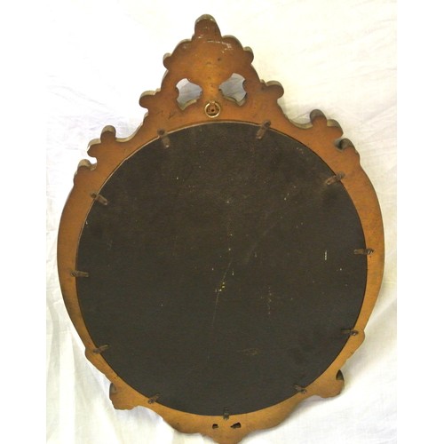 314 - Oval gilt framed wall mirror in an ornate scroll pierced frame