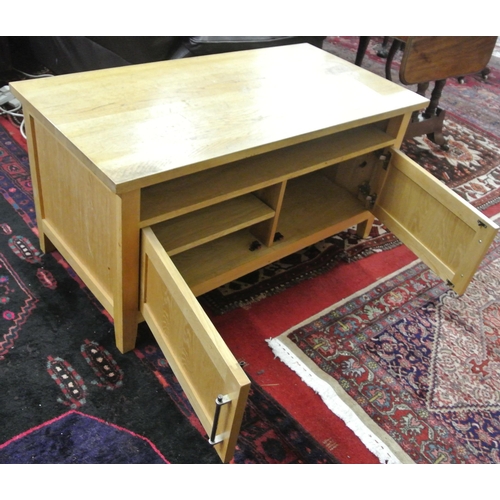 131 - Oblong Pine side or television cabinet with panelled doors, shelved interior, on bracket feet