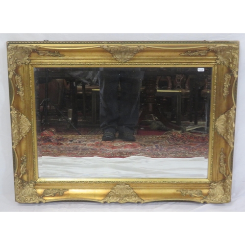 147 - Regency design gilt framed bevelled glass wall mirror with ornate foliate decoration