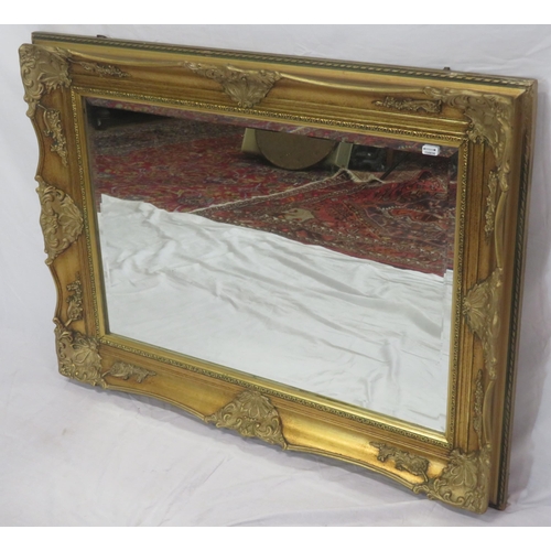 147 - Regency design gilt framed bevelled glass wall mirror with ornate foliate decoration