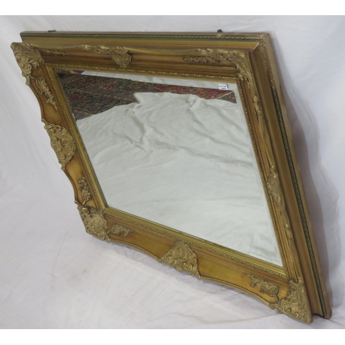 147 - Regency design gilt framed bevelled glass wall mirror with ornate foliate decoration