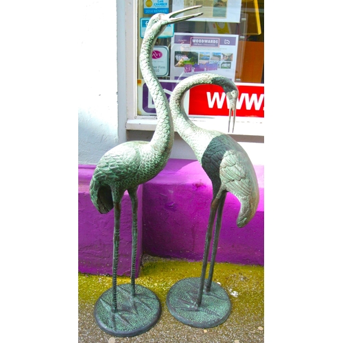 202 - Pair of tall metal garden crane statues on round bases