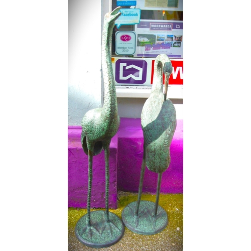 202 - Pair of tall metal garden crane statues on round bases