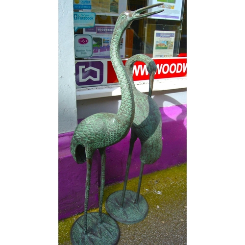 202 - Pair of tall metal garden crane statues on round bases