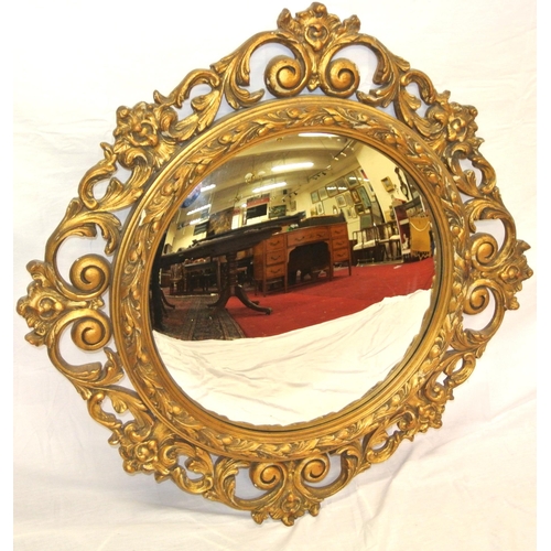 257 - Regency style round gilt framed convex mirror with ornate scroll and foliate decoration