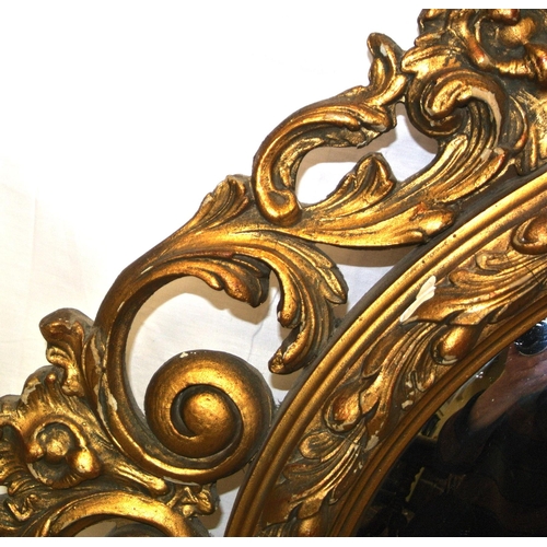 257 - Regency style round gilt framed convex mirror with ornate scroll and foliate decoration