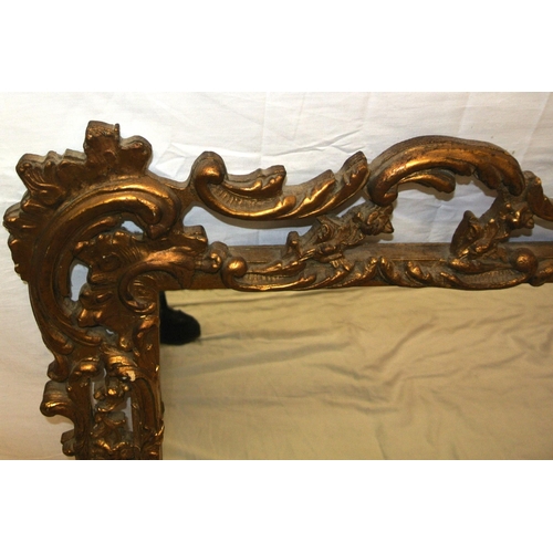 273 - Regency design gilt framed wall mirror with ornate foliate, shell and scroll decoration