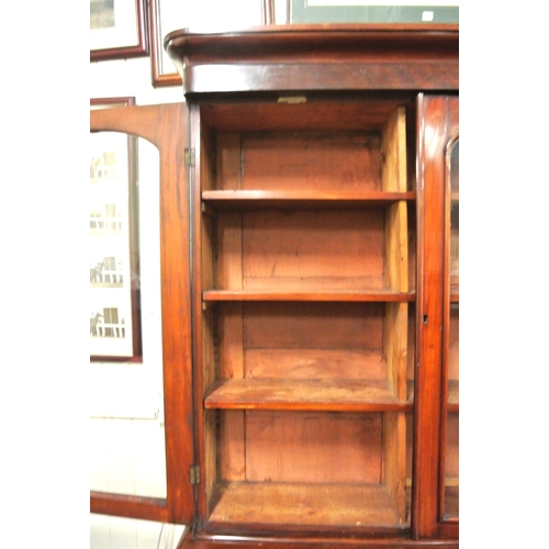 285 - Victorian mahogany triple bookcase with shaped frieze, glazed doors with shelved interior, drawers u... 