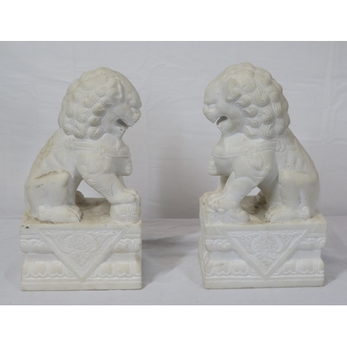 288 - Pair of Oriental carved marble Foo dogs with with oblong foliate decorated bases