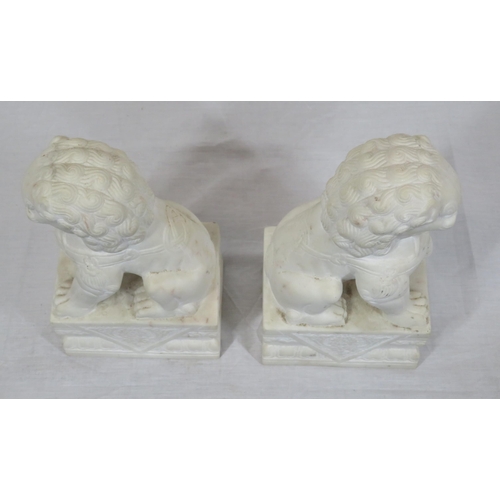 288 - Pair of Oriental carved marble Foo dogs with with oblong foliate decorated bases