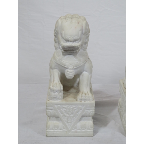 288 - Pair of Oriental carved marble Foo dogs with with oblong foliate decorated bases