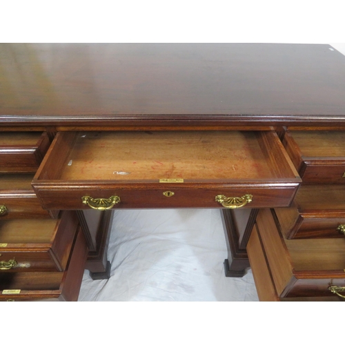 310 - Edwardian mahogany kneehole desk with 9 drawers, brass drop handles with pierced backplates, on brac... 