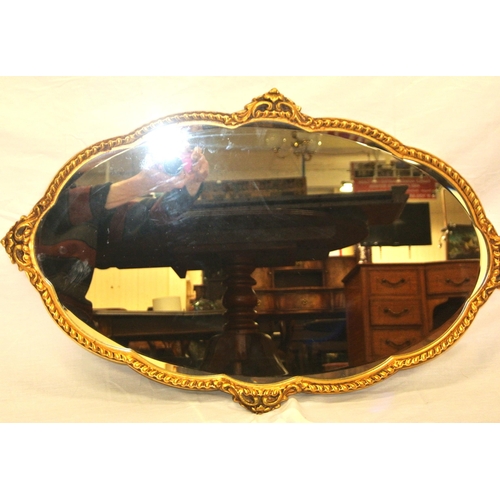 319 - Regency design oval bevelled glass shaped wall mirror