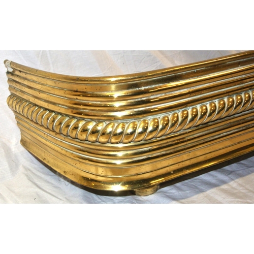 326 - Georgian brass fire fender with ornate rope-edge decoration and lion claw feet