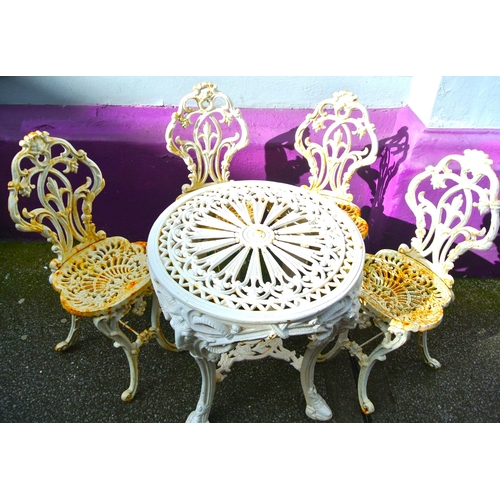 330 - Ornate cast iron 5 piece patio or garden suite: round table with ram head and foliate decoration, 4 ... 