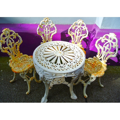 330 - Ornate cast iron 5 piece patio or garden suite: round table with ram head and foliate decoration, 4 ... 