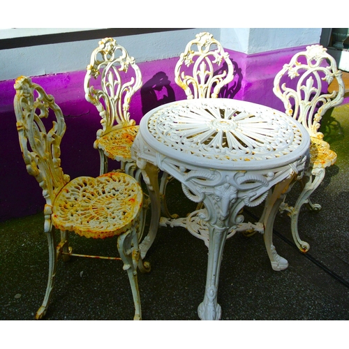 330 - Ornate cast iron 5 piece patio or garden suite: round table with ram head and foliate decoration, 4 ... 