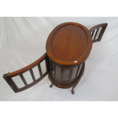 335 - Edwardian design oval butlers cabinet with serving tray, bevelled glass insets, on sabre legs