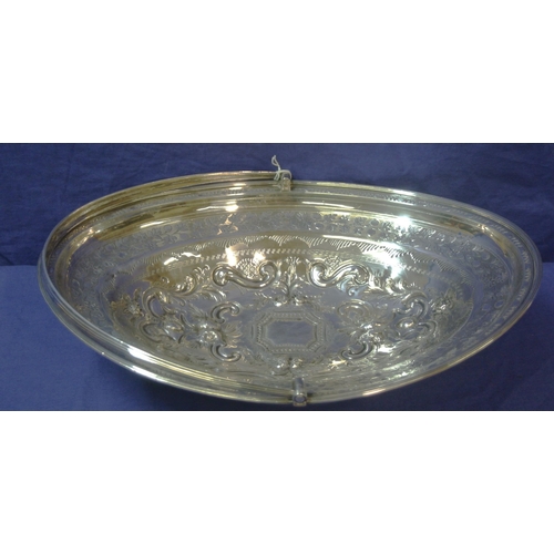 100 - London George III silver oval basket with reeded swing handle and rim, ornate foliate and scroll dec... 