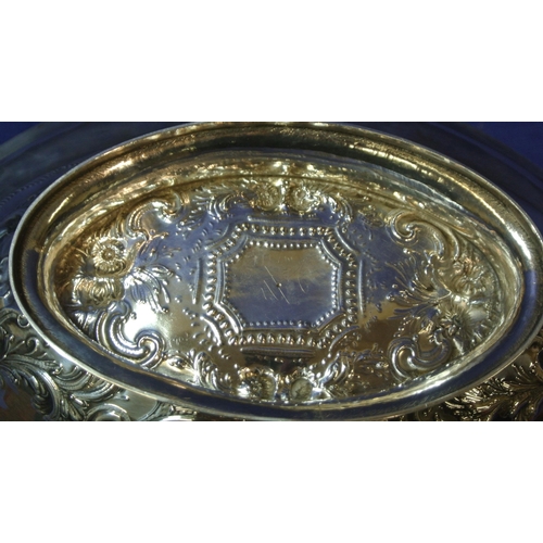 100 - London George III silver oval basket with reeded swing handle and rim, ornate foliate and scroll dec... 