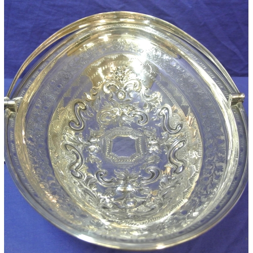 100 - London George III silver oval basket with reeded swing handle and rim, ornate foliate and scroll dec... 