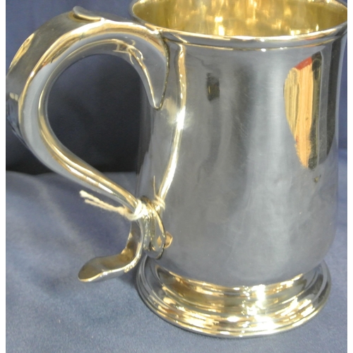 113 - George III London silver mug of baluster form, crested,  with initialled scroll handle and round spr... 