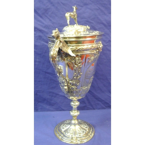 125 - Sheffield Victorian silver trophy cup of round tapering form decorated with winged lions, faces, scr... 