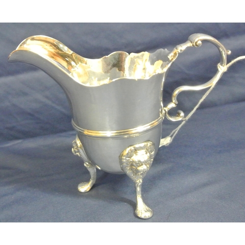 206 - Irish George III Silver cream jug with wavy rim, leaf capped scroll handle, central rim, on cast pad... 