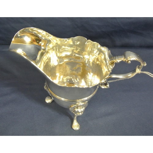 206 - Irish George III Silver cream jug with wavy rim, leaf capped scroll handle, central rim, on cast pad... 