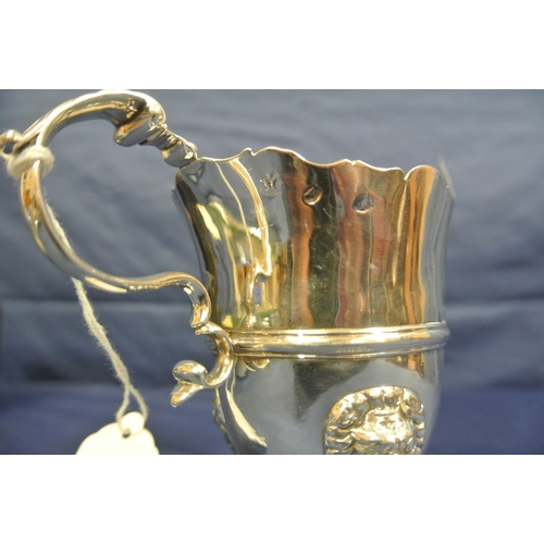 206 - Irish George III Silver cream jug with wavy rim, leaf capped scroll handle, central rim, on cast pad... 