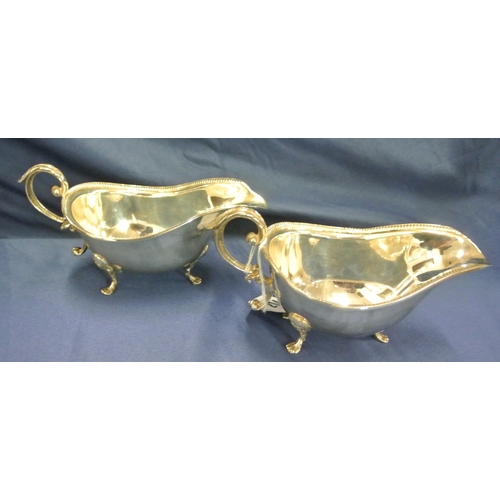 214 - Pair of Irish Provincial Silver boat shaped gravy or sauceboats with gadroon rims, leaf capped S-scr... 