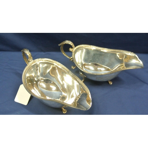 214 - Pair of Irish Provincial Silver boat shaped gravy or sauceboats with gadroon rims, leaf capped S-scr... 