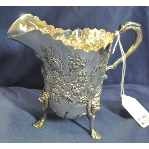 217 - Irish silver cream jug and matching sugar bowl with wavy rims, leaf capped scroll handle, profusely ... 