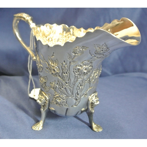 217 - Irish silver cream jug and matching sugar bowl with wavy rims, leaf capped scroll handle, profusely ... 