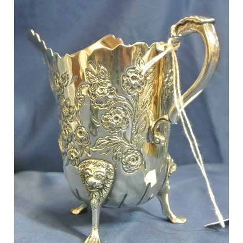 217 - Irish silver cream jug and matching sugar bowl with wavy rims, leaf capped scroll handle, profusely ... 