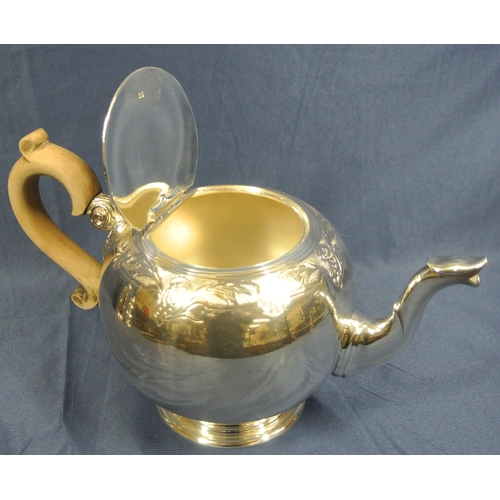 221 - Irish silver teapot of ball form with foliate chased band, shaped spout and timber handle, on round ... 