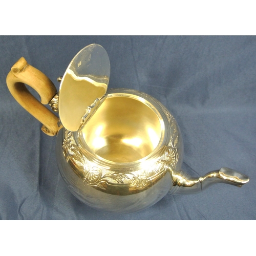 221 - Irish silver teapot of ball form with foliate chased band, shaped spout and timber handle, on round ... 