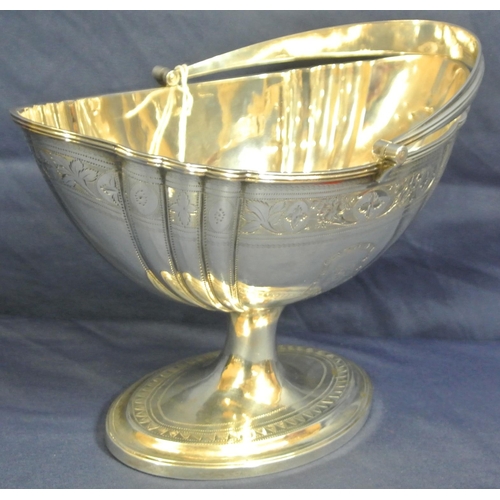 222 - Irish George III silver sugar basket with reeded swing handle, reeded rim, ribbed and foliate decora... 