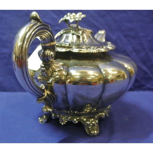 230 - Irish Silver Victorian teapot of melon panelled form, lid with floral finial, scroll handle and shap... 