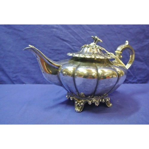 230 - Irish Silver Victorian teapot of melon panelled form, lid with floral finial, scroll handle and shap... 