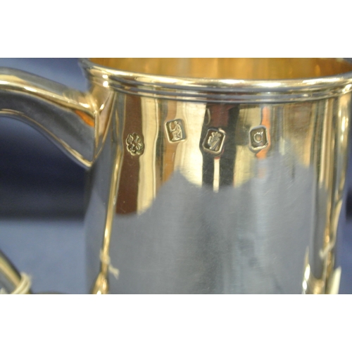 240 - Pair of Irish Silver tankards of round tapering form with reeded rims, shaped handles, on stepped ba... 