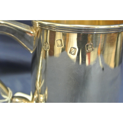 240 - Pair of Irish Silver tankards of round tapering form with reeded rims, shaped handles, on stepped ba... 