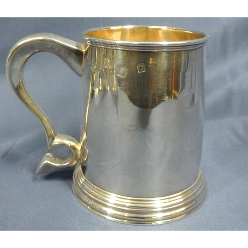 240 - Pair of Irish Silver tankards of round tapering form with reeded rims, shaped handles, on stepped ba... 