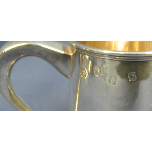 240 - Pair of Irish Silver tankards of round tapering form with reeded rims, shaped handles, on stepped ba... 