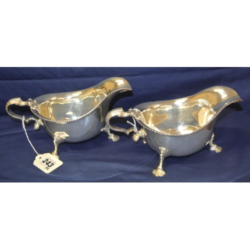 243 - Pair of Irish Silver boat shaped sauceboats with gadroon rims, scroll handles, on cast feet, by Roya... 