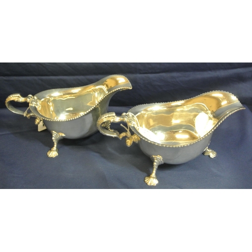 243 - Pair of Irish Silver boat shaped sauceboats with gadroon rims, scroll handles, on cast feet, by Roya... 