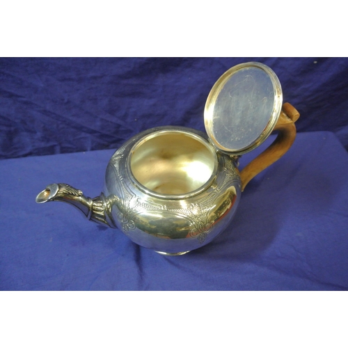 244 - Irish silver teapot of ball form, lid with marble finial, shaped spout and timber handle, foliate ch... 