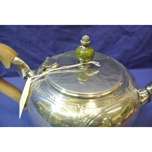 244 - Irish silver teapot of ball form, lid with marble finial, shaped spout and timber handle, foliate ch... 