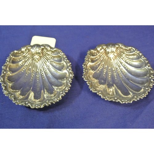 27 - Pair of silver plated shell shaped bon-bon dishes with scroll rims, each on 3 ball feet