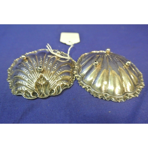 27 - Pair of silver plated shell shaped bon-bon dishes with scroll rims, each on 3 ball feet